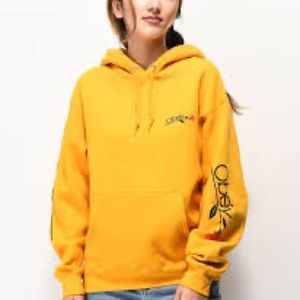 Yellow hoodie with rose design on the side arms and obey logo on hoodie